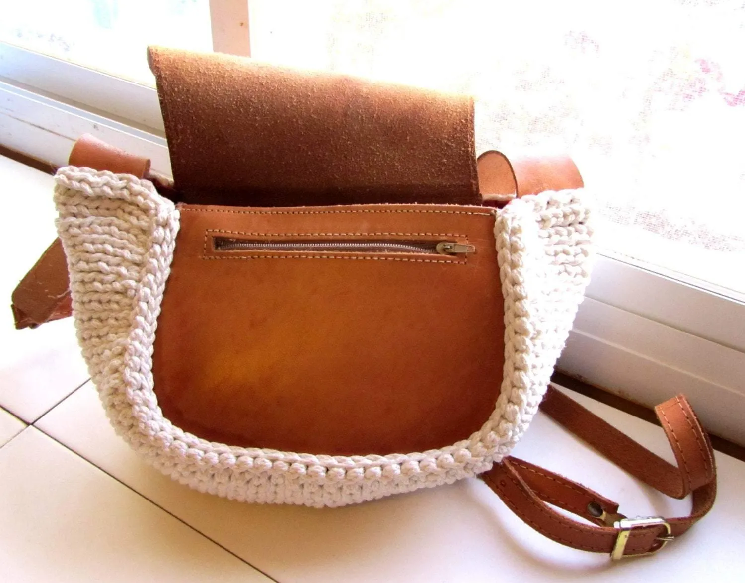 Crossbody / Shoulder bag made out of thick leather with a knitted fragment on a long leather strap