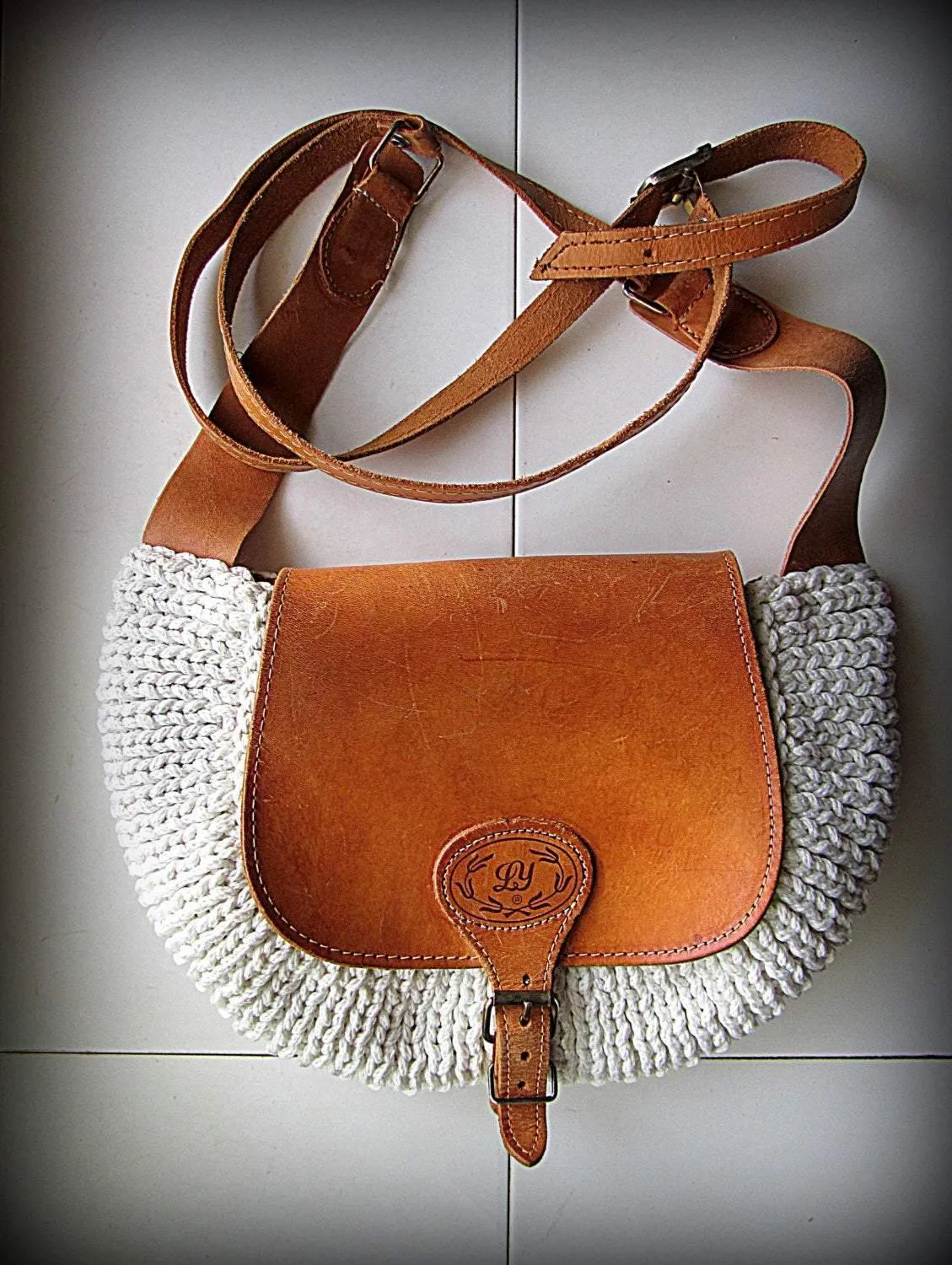 Crossbody / Shoulder bag made out of thick leather with a knitted fragment on a long leather strap