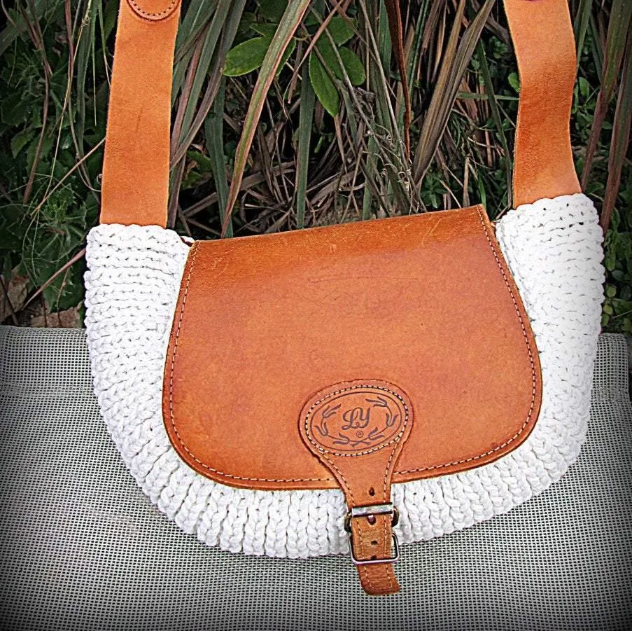 Crossbody / Shoulder bag made out of thick leather with a knitted fragment on a long leather strap