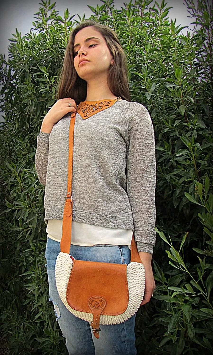 Crossbody / Shoulder bag made out of thick leather with a knitted fragment on a long leather strap